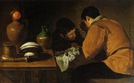 Zwei junge Männer, Essen in einem Humble Table Zwei junge Männer, Essen in einem Humble Table