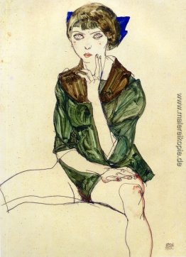 Sitzende Frau in eine grüne Bluse Sitzende Frau in eine grüne Bluse