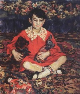 Portrait des Mädchens sitzend auf einem bunten Teppich mit dem S Portrait des Mädchens sitzend auf einem bunten Teppich mit dem S